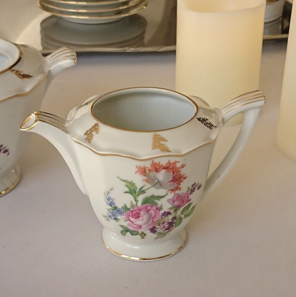 Sugar bowl and milk jar in flowery white porcelain