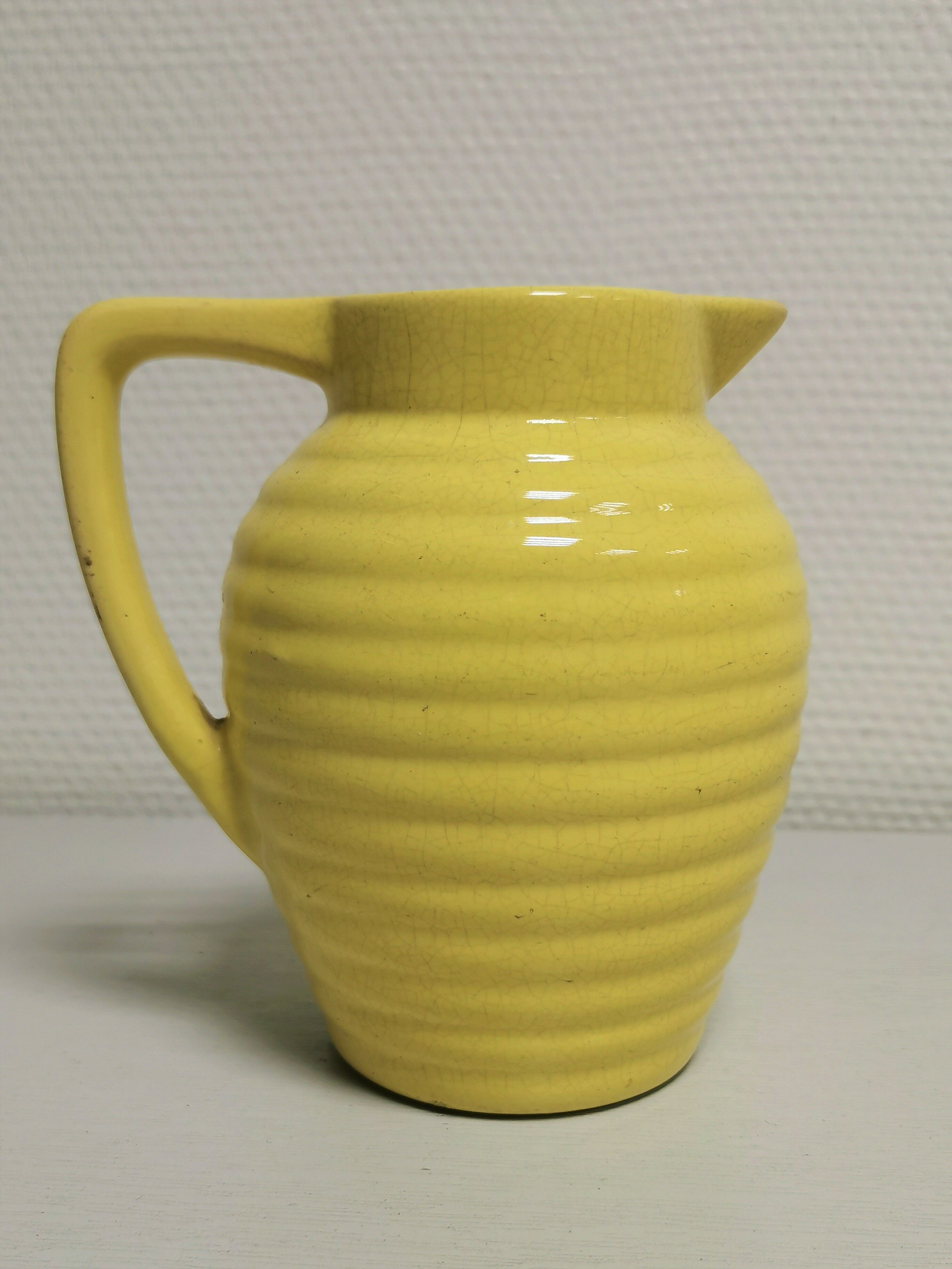 Yellow pitcher in slurry, faience onnaing frères
