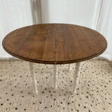 Extendable round table in raw and white wood