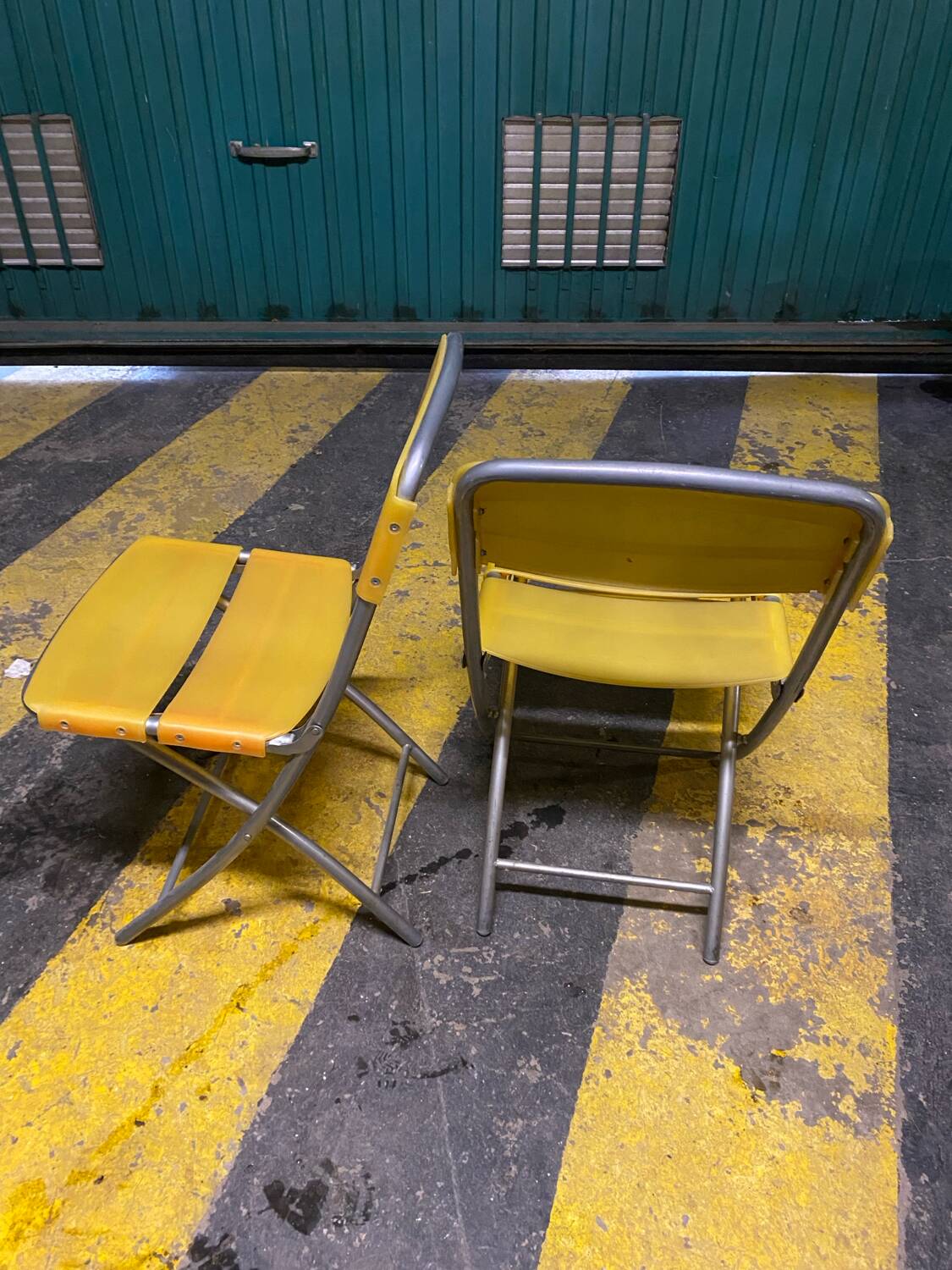 Yellow plastic and steel folding chairs, 1970s