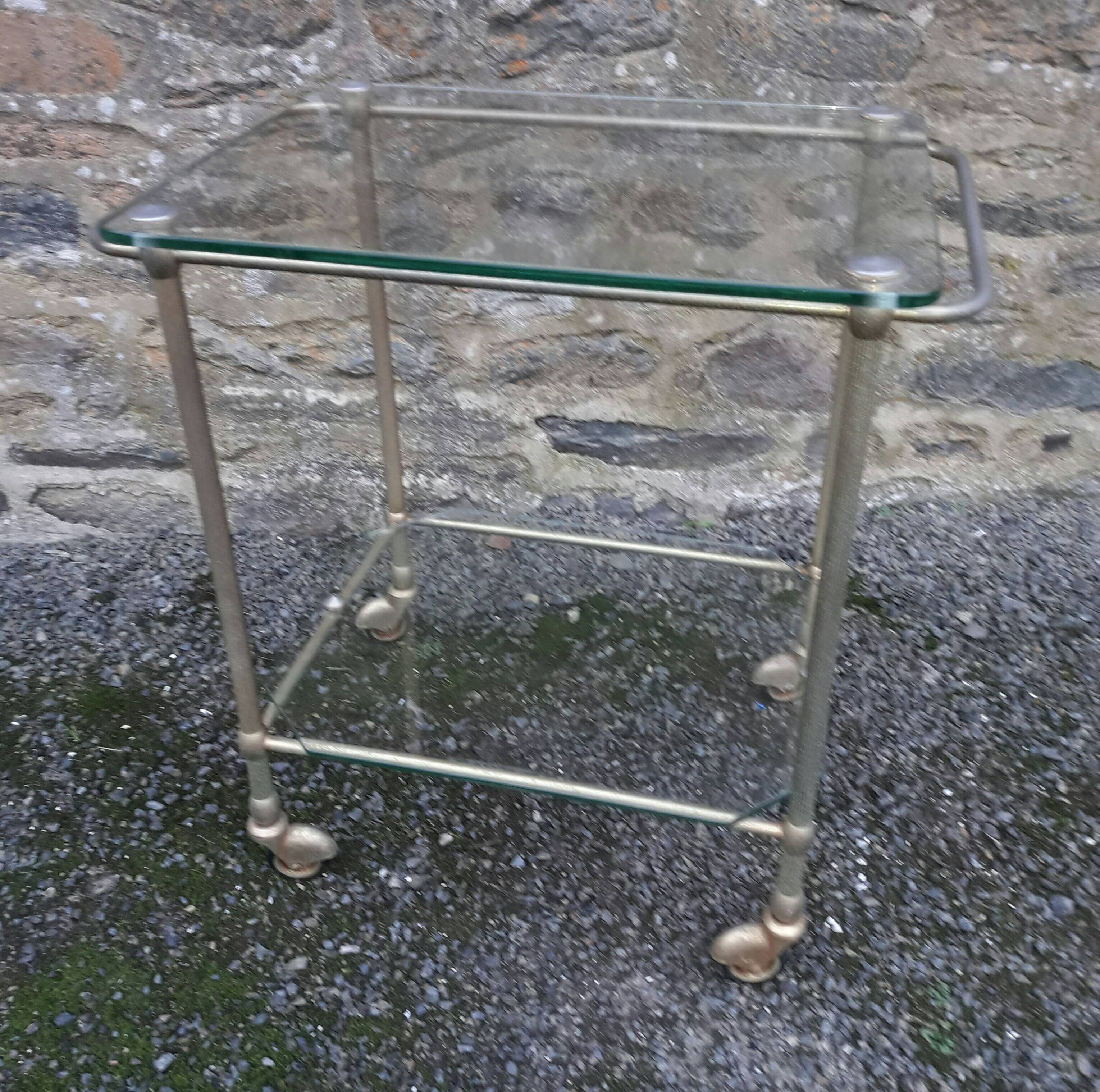 Small rolling table in glass and gold metal