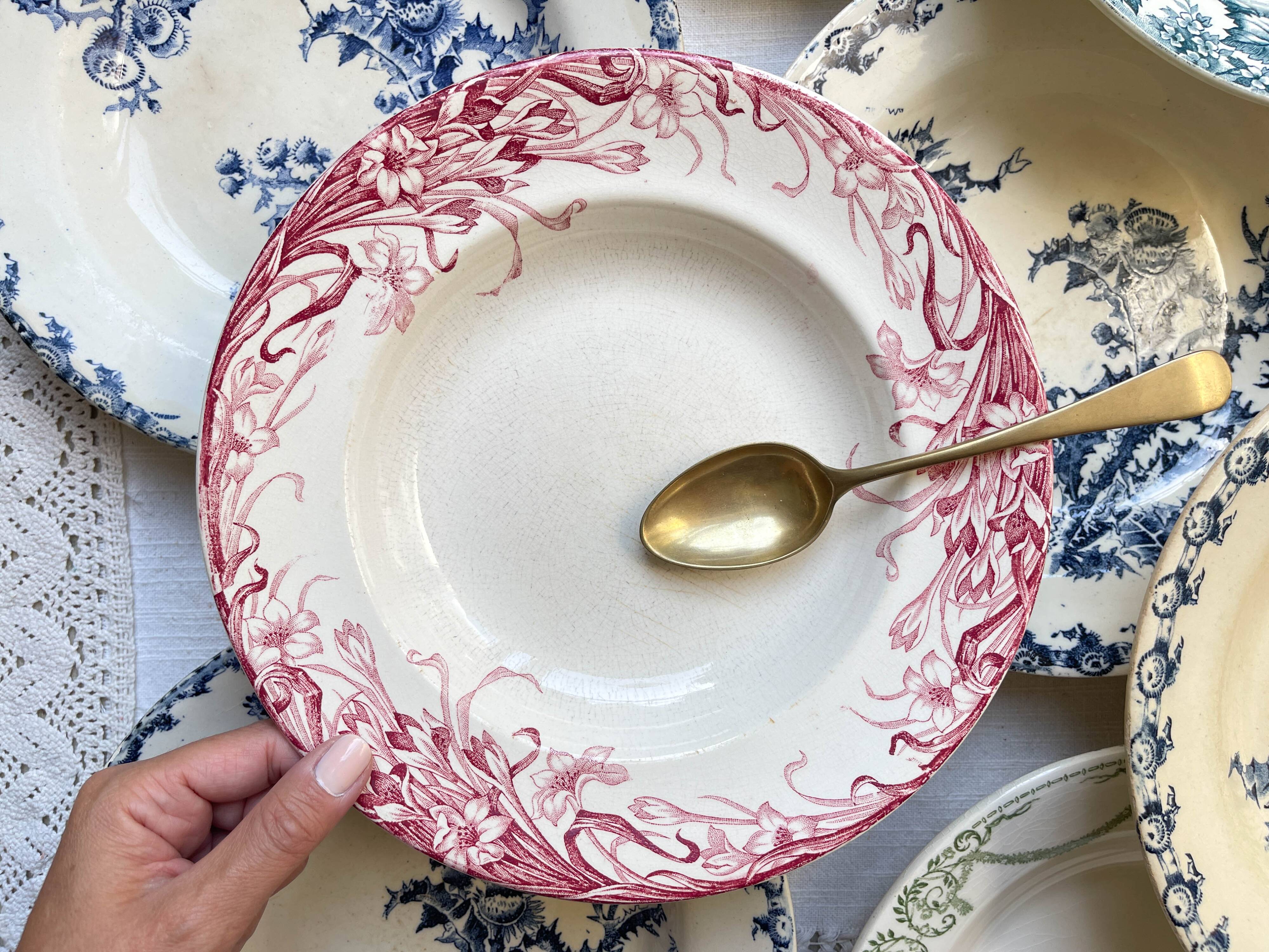 10 mismatched vintage soup plates in blue, green, and red ironstone