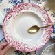 10 mismatched vintage soup plates in blue, green, and red ironstone