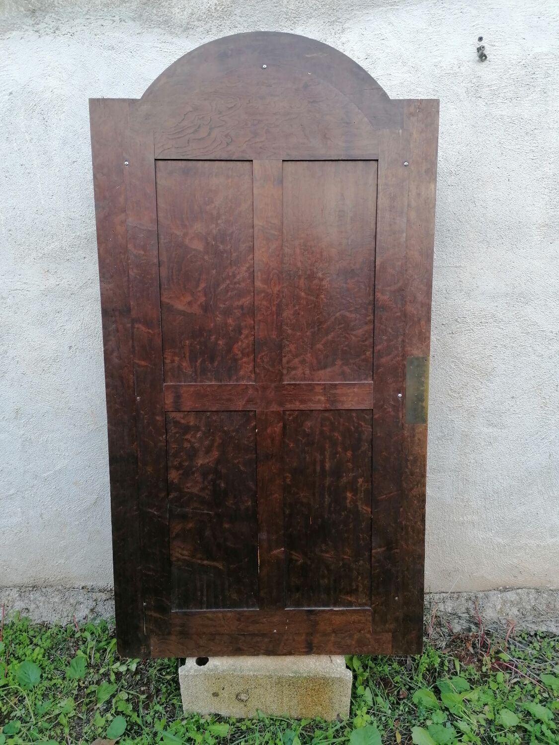 Old beveled solid wood mirror of a cabinet door.