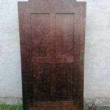 Old beveled solid wood mirror of a cabinet door.