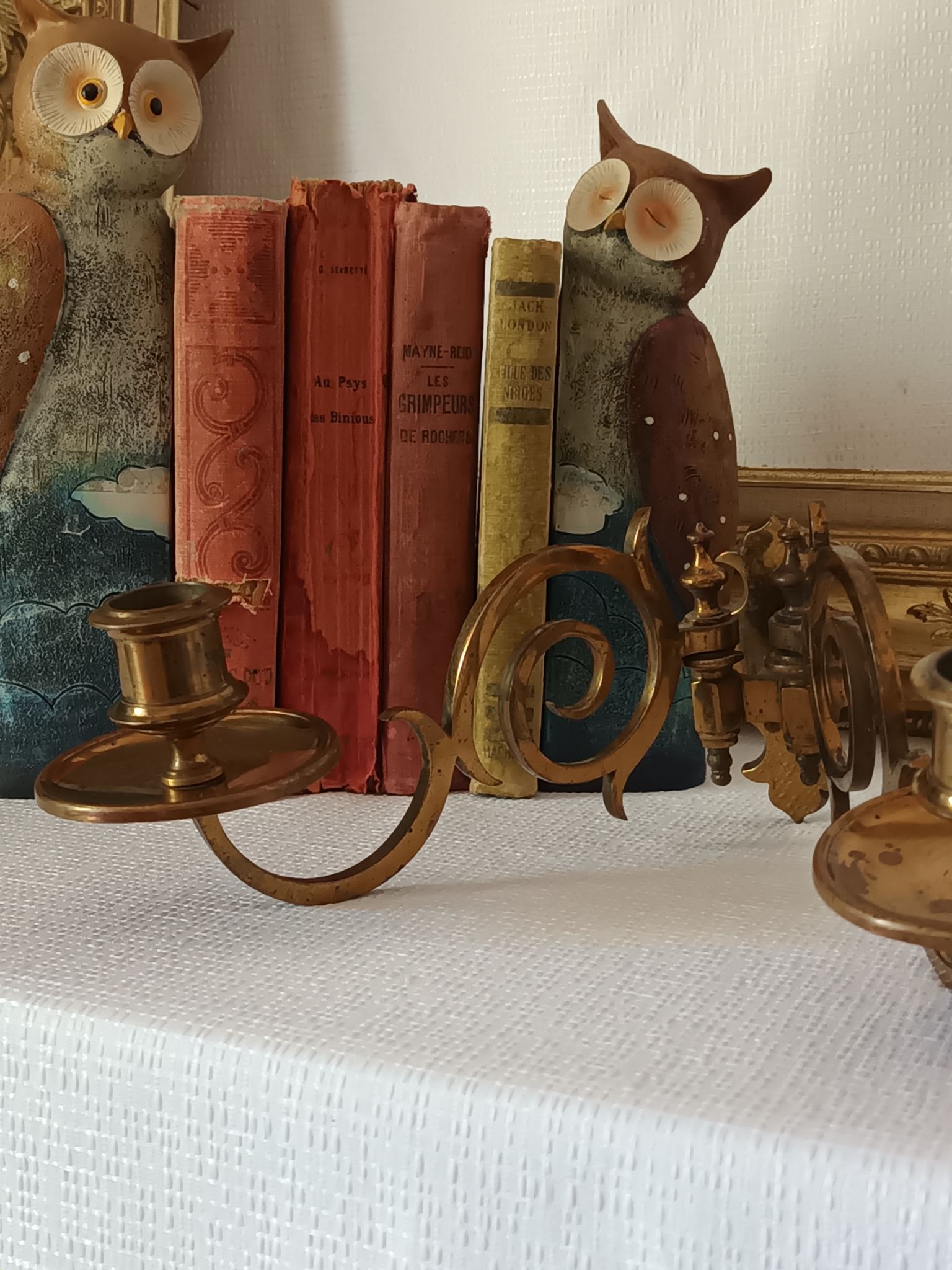 Pair of antique wall-mounted brass candle holders