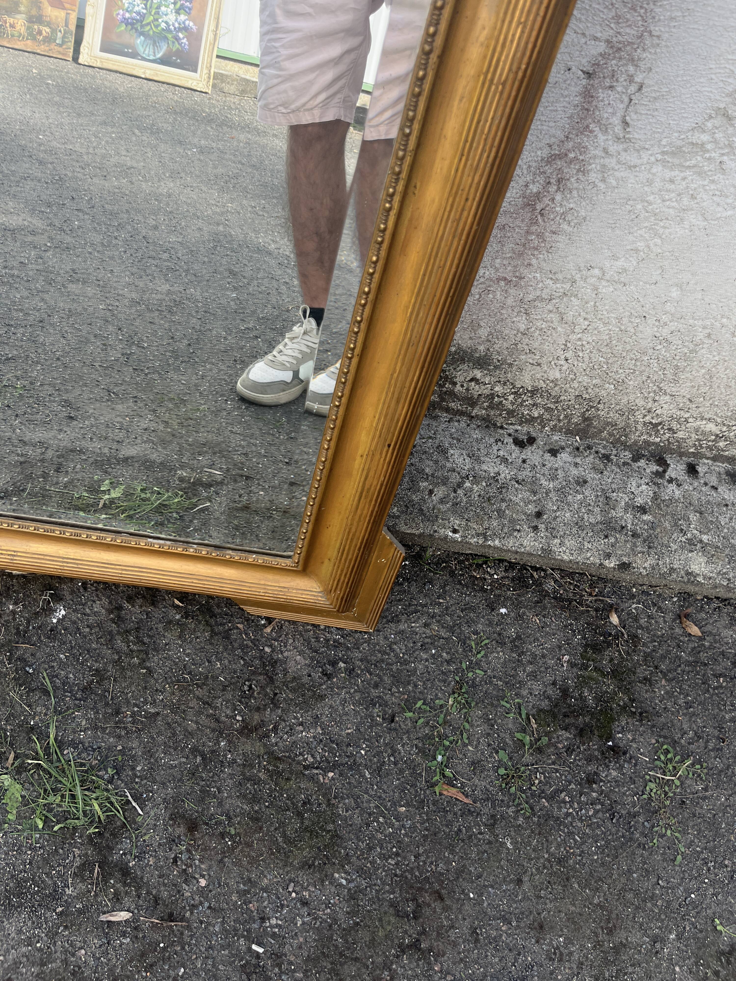 Large antique gilded mirror with carved pediment, 126 cm
