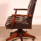 Office chair known as a director's chair in wood and tufted leather.