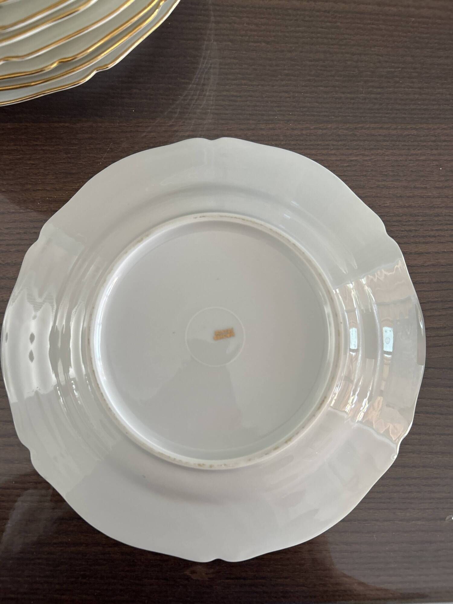 This white porcelain plate features a scalloped edge and elegance.