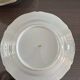 This white porcelain plate features a scalloped edge and elegance.