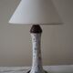 Table lamp for bedside use in earthenware with a wooden base.