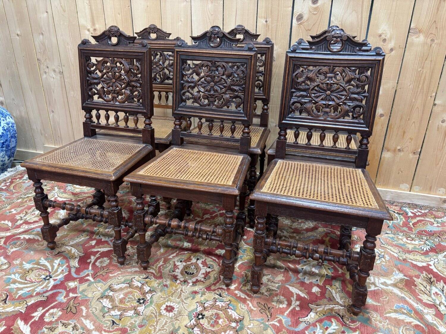 6 High Era chairs in carved solid oak and rattan caning.