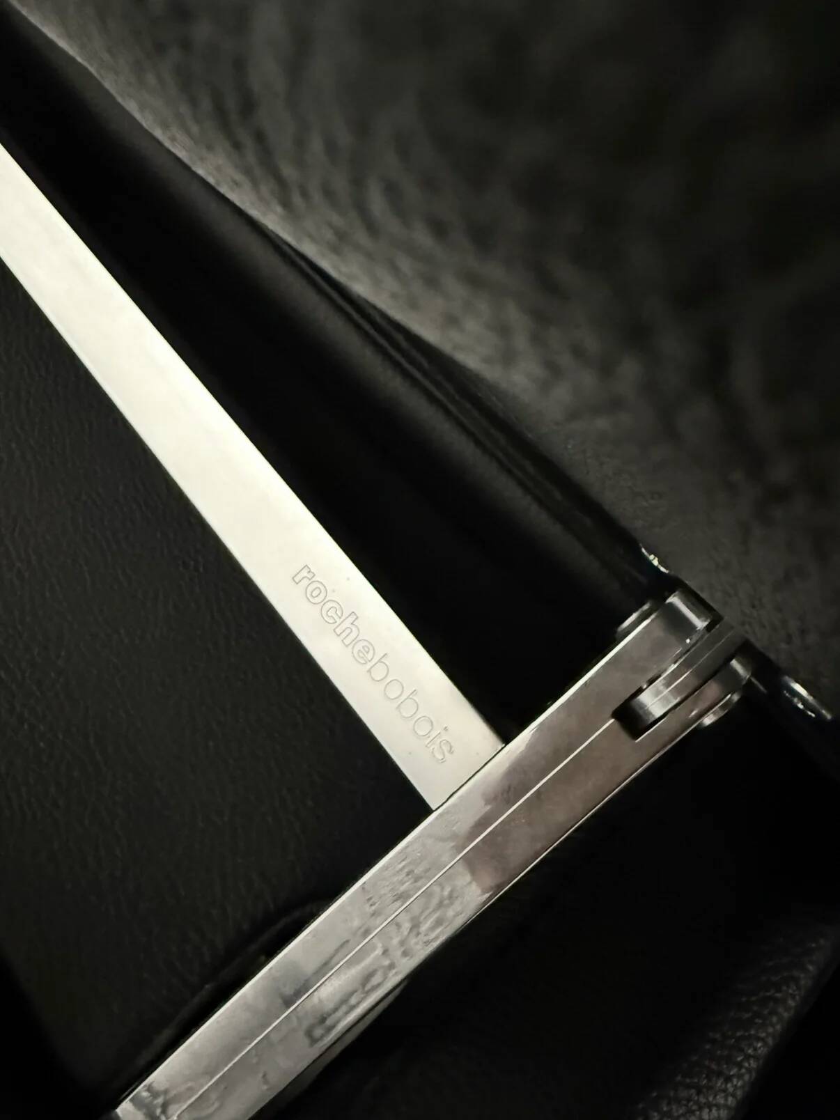 Two-seater black leather sofa from Roche Bobois with a chrome frame.
