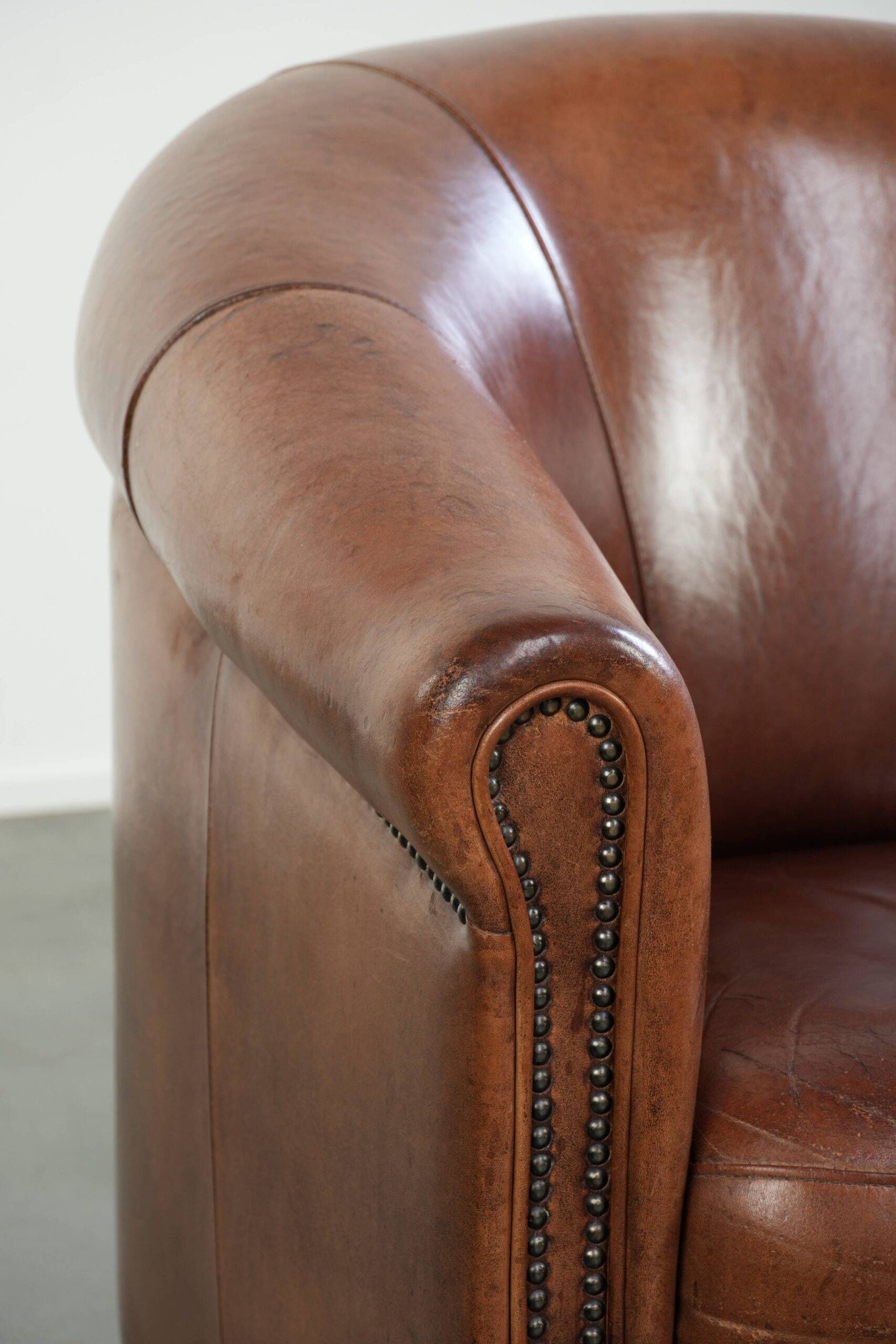Vintage sheepskin club armchair in English style with deep colours
