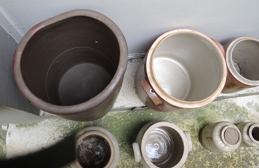 Collection of old sandstone pots with grease and mustard salting