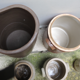 Collection of old sandstone pots with grease and mustard salting