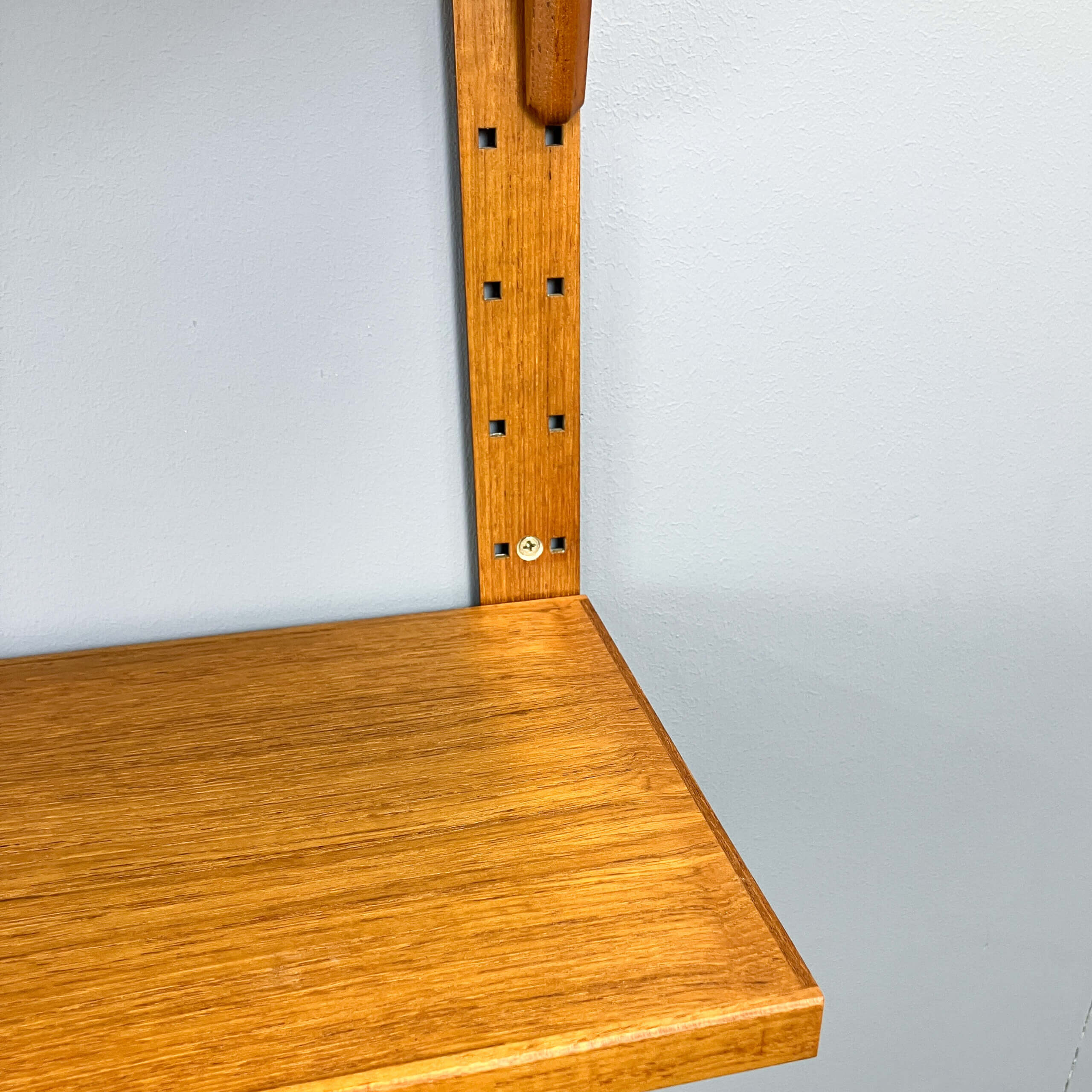 Danish wall shelf by Hansen and Guldborg, teak, aluminum rails, 1960s.