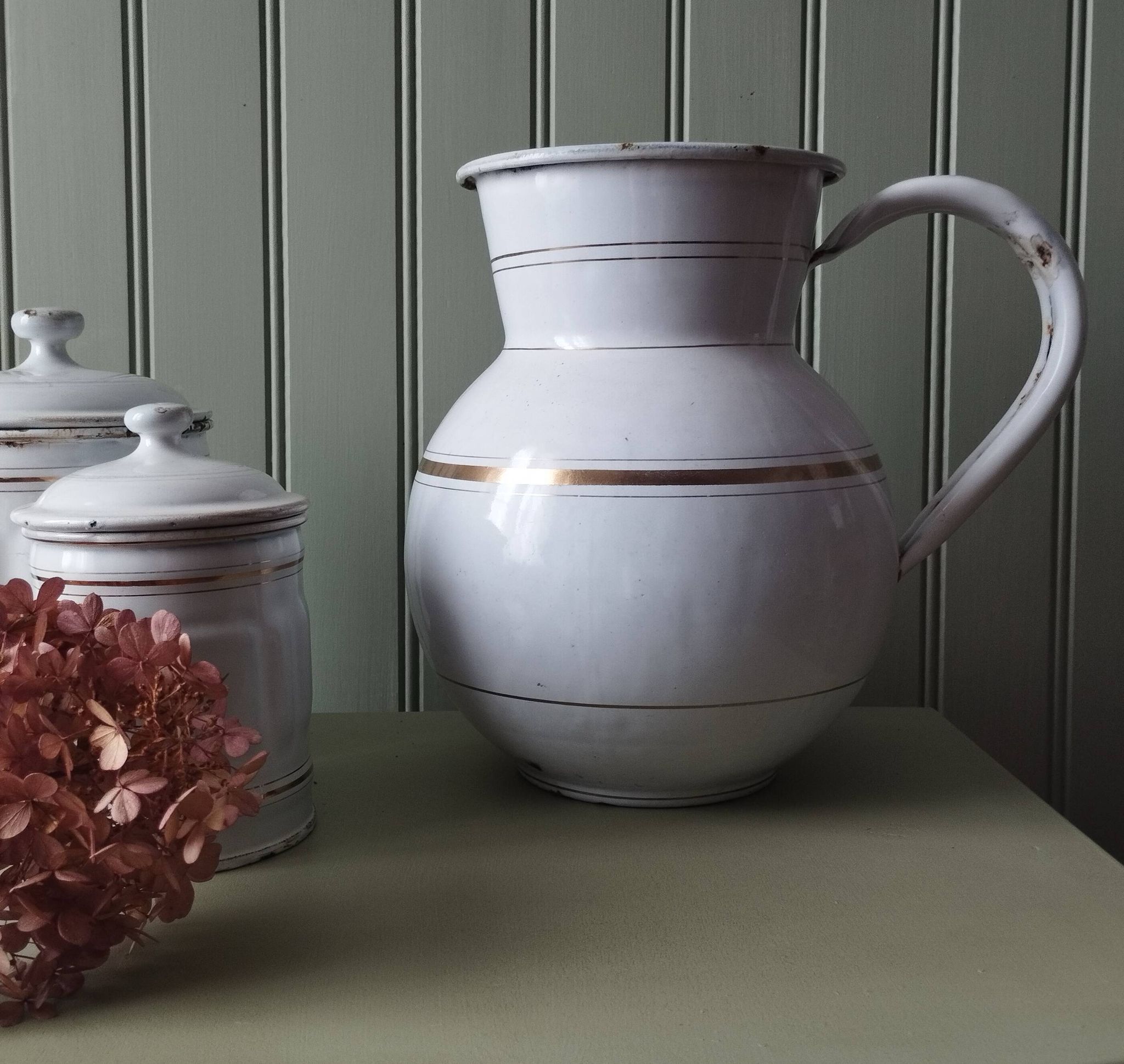Rare large, pot-bellied toilet jug in white enamelled sheet metal with gold edging