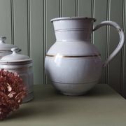 Rare large, pot-bellied toilet jug in white enamelled sheet metal with gold edging