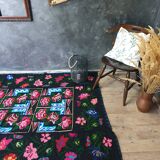 Handwoven floral wool rug, black background with pink roses and geometric design 207x144cm