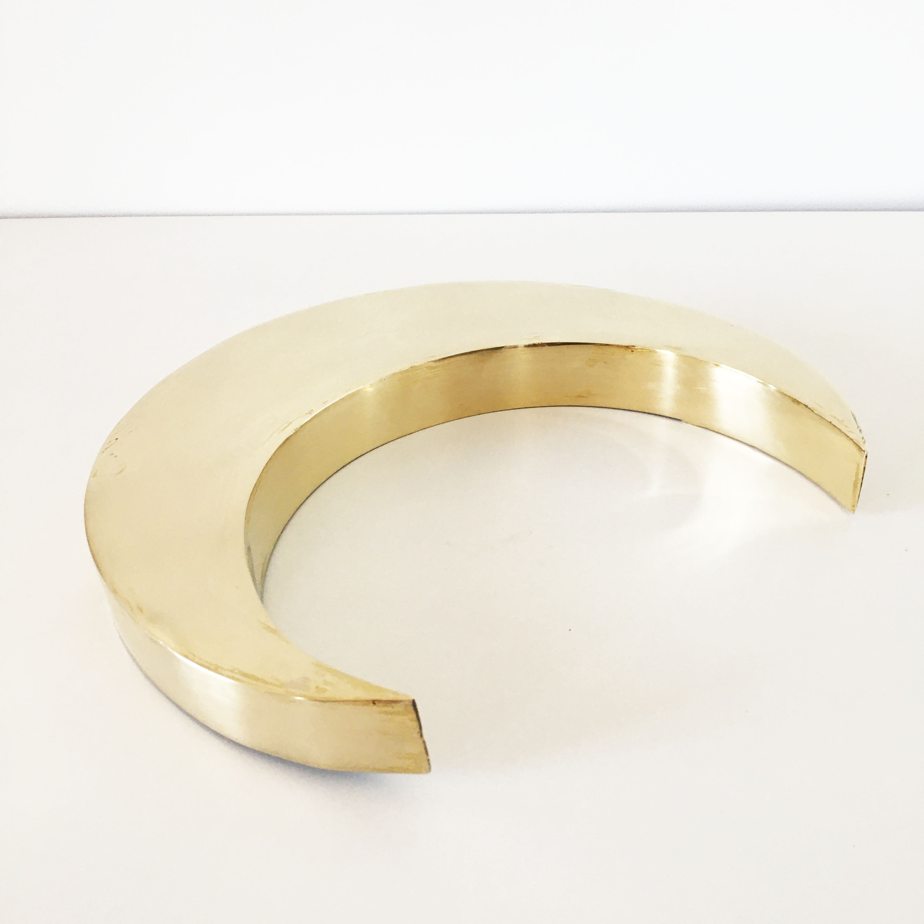 Moon or letter of sign "C" in vintage brass