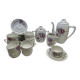 Porcelain coffee service with floral decoration and silver trim.
