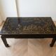 Chinese coffee table in black and gold wood.