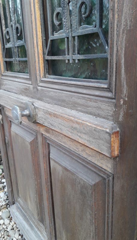 Oak entrance door and its frame and transom, wrought iron gates