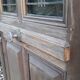 Oak entrance door and its frame and transom, wrought iron gates