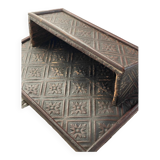 Hammered leather wall mail holder on wood.