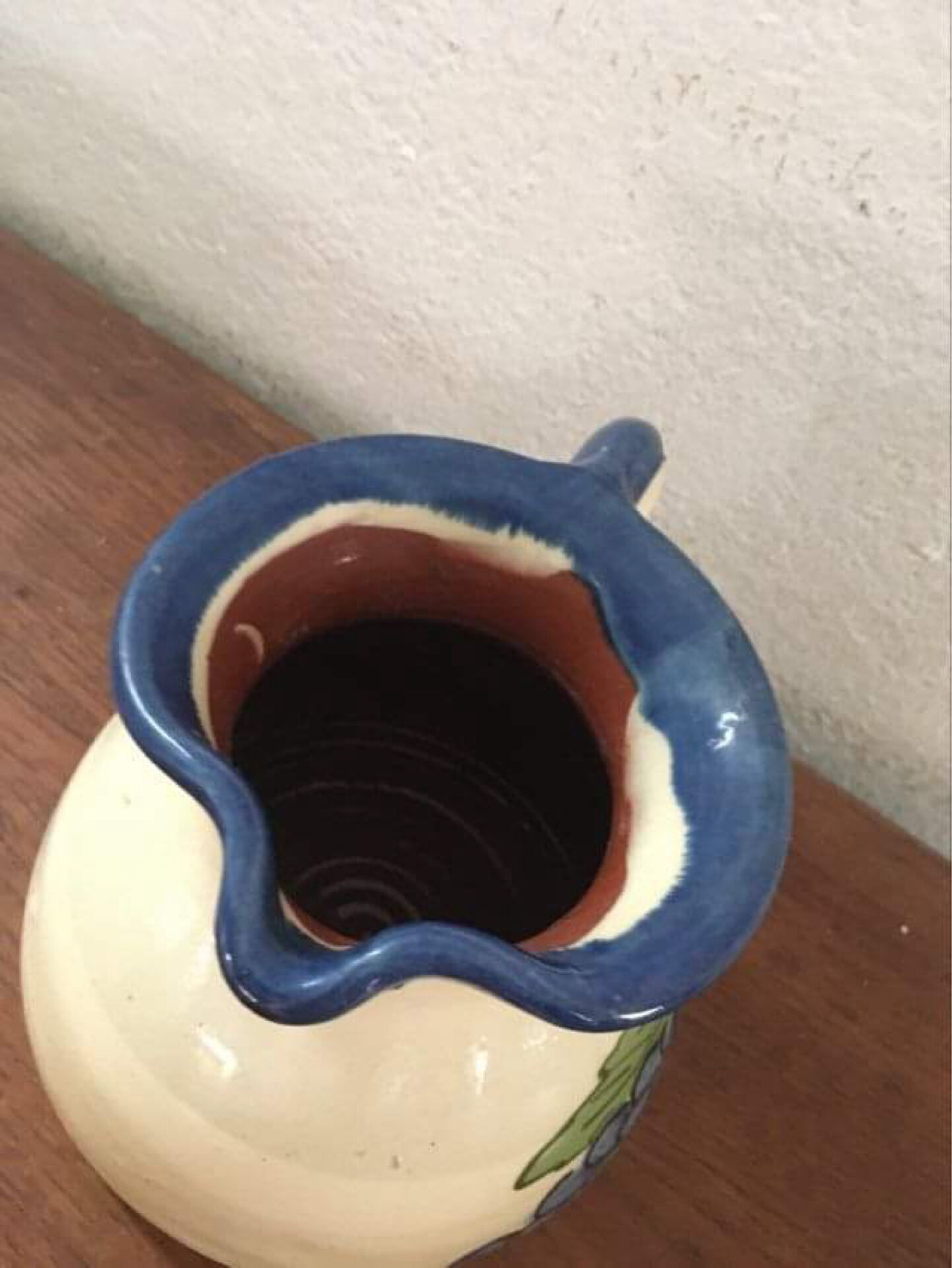 Terracotta jug with grape decoration.