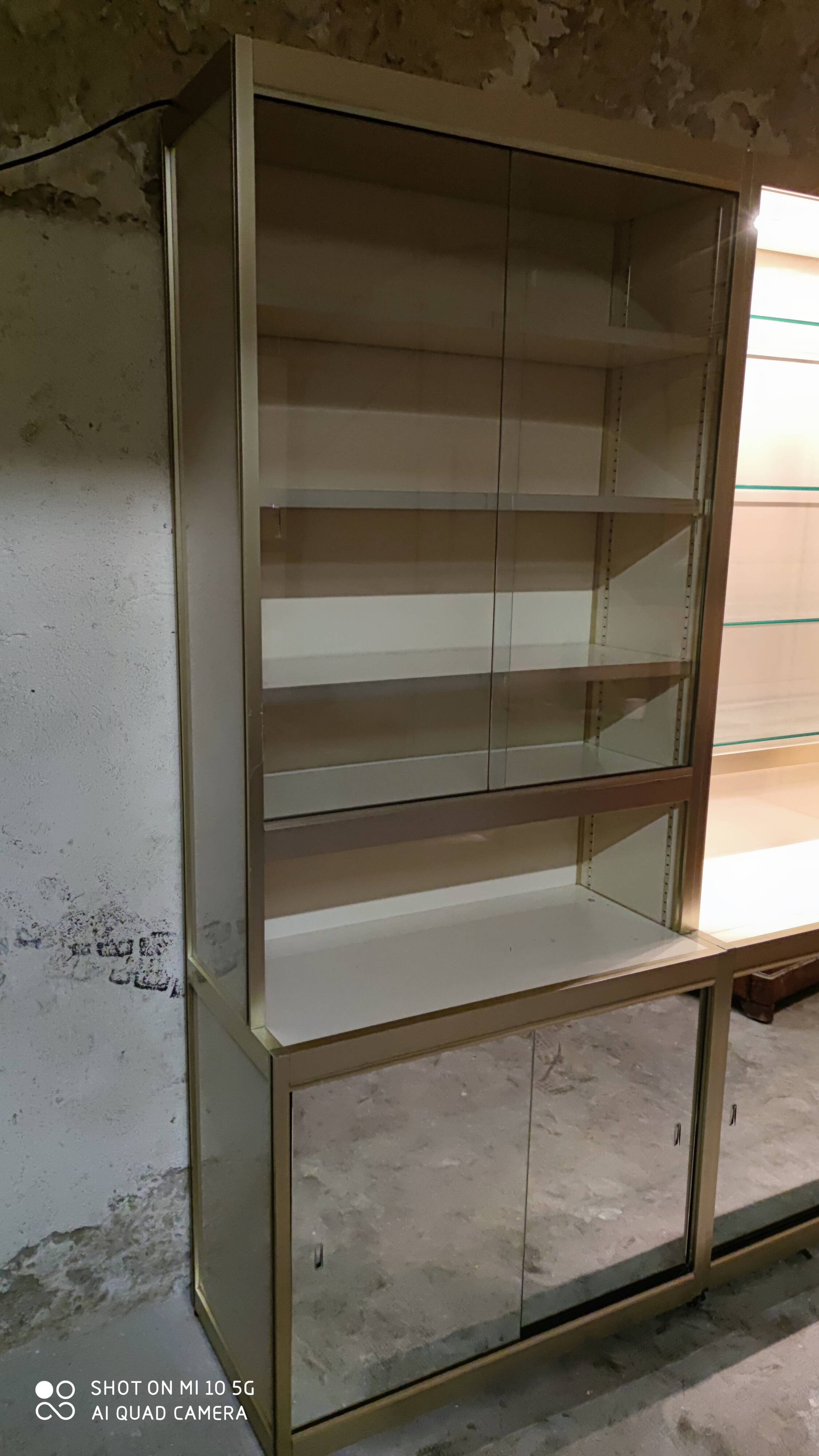 Ivory-colored and matte gold anodized aluminum display bookcase