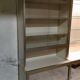 Ivory-colored and matte gold anodized aluminum display bookcase