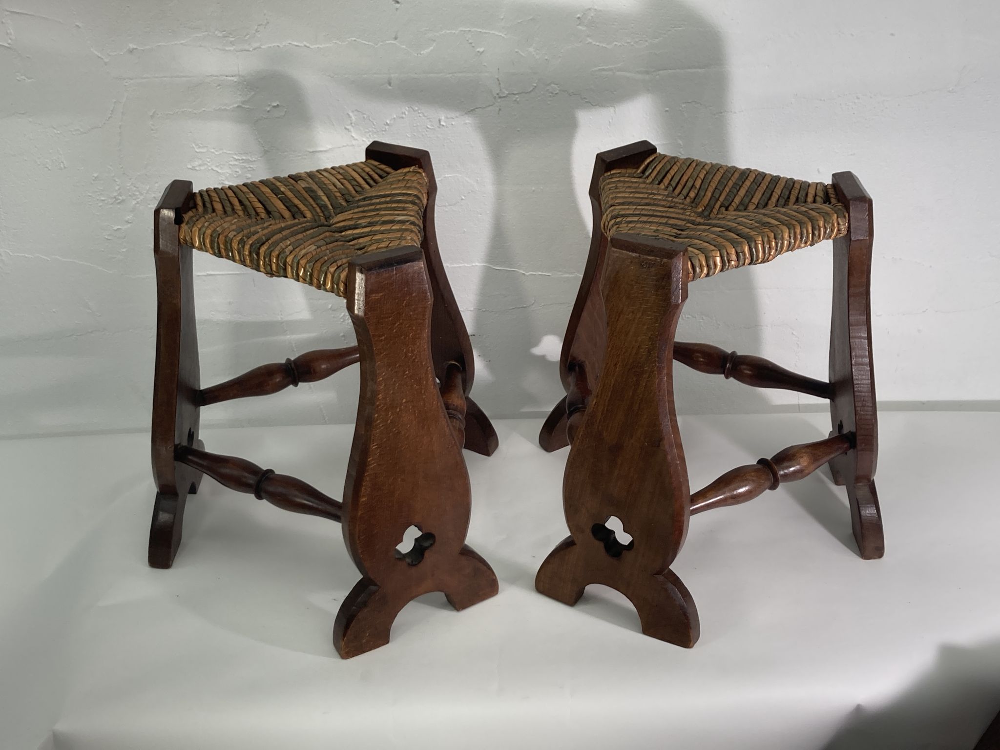 Pair of brutalist neo gothic rush oak tripod stools, France ca 1960s