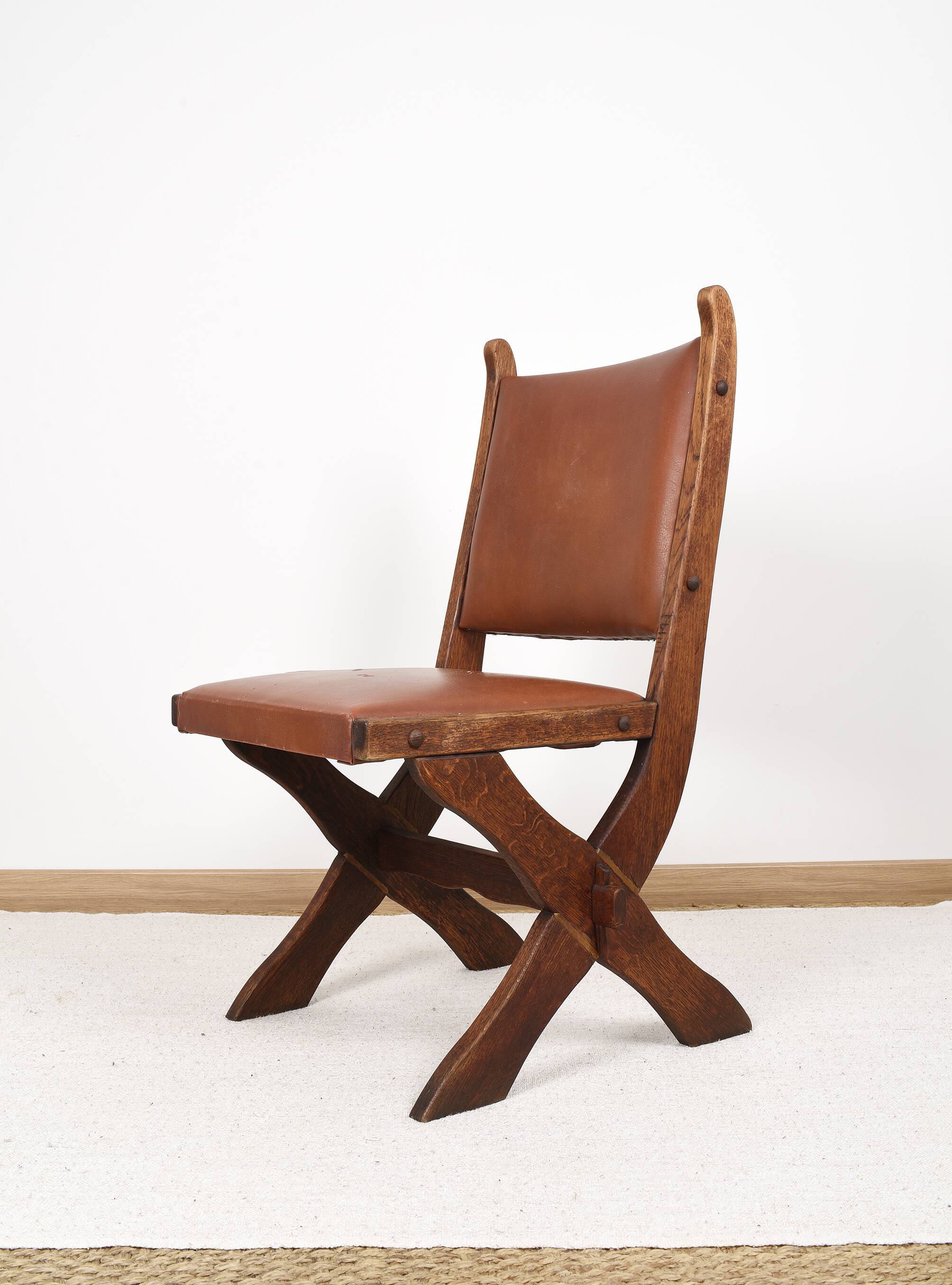 Pair of brutalist style chairs, in wood and leather.