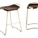 Brown stool pair without backrest with brass details.