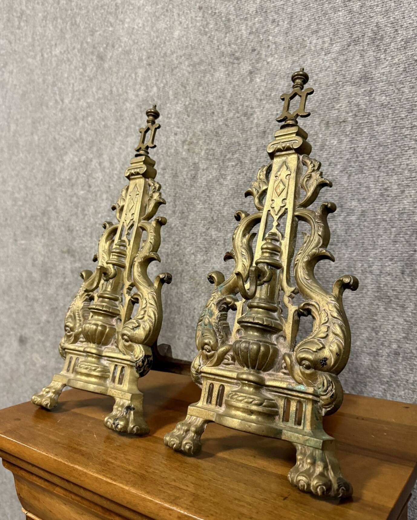 pair of Empire period dolphin firedogs in gilded bronze
