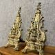 pair of Empire period dolphin firedogs in gilded bronze