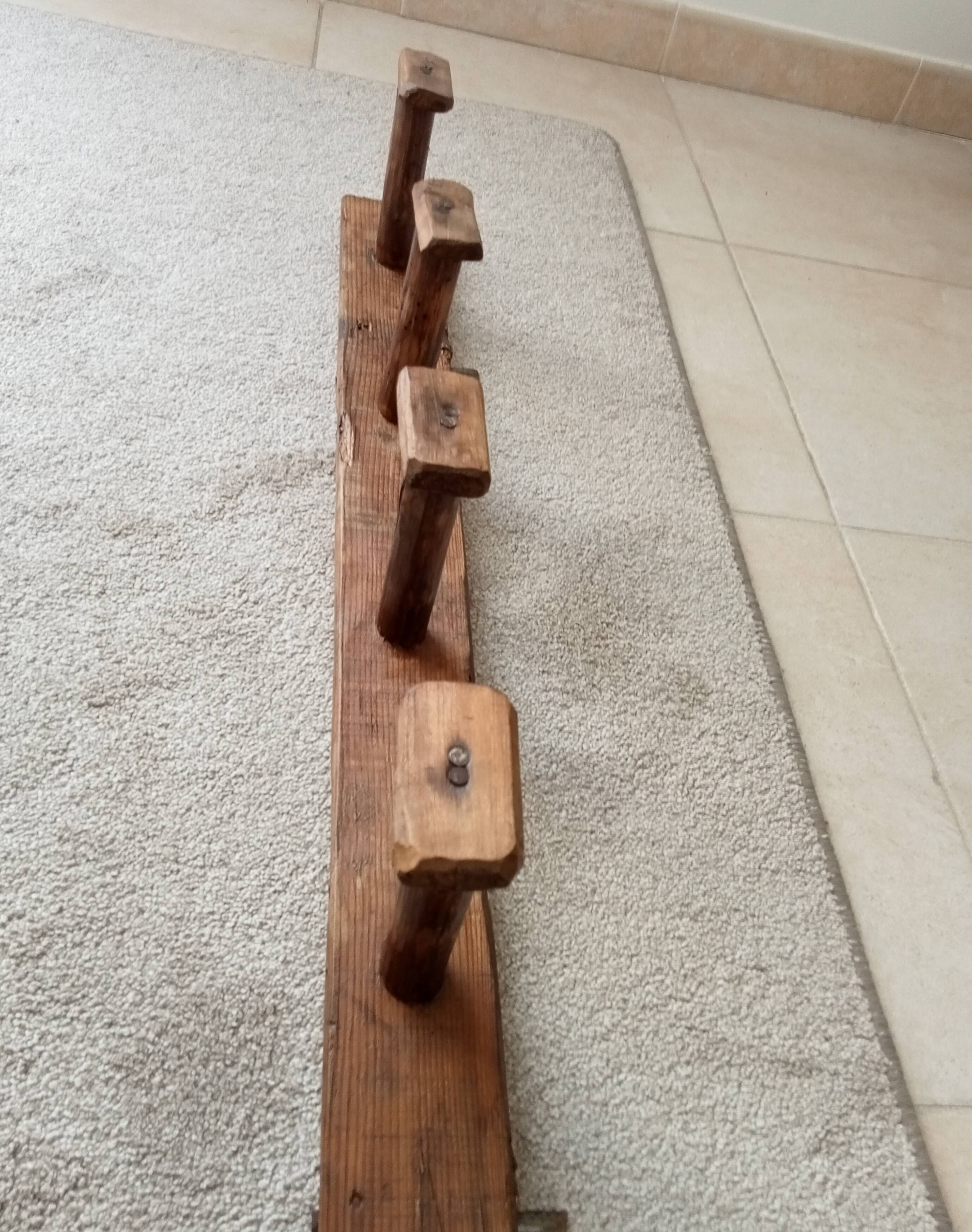 Old wall-mounted coat rack from a stable, folk art.