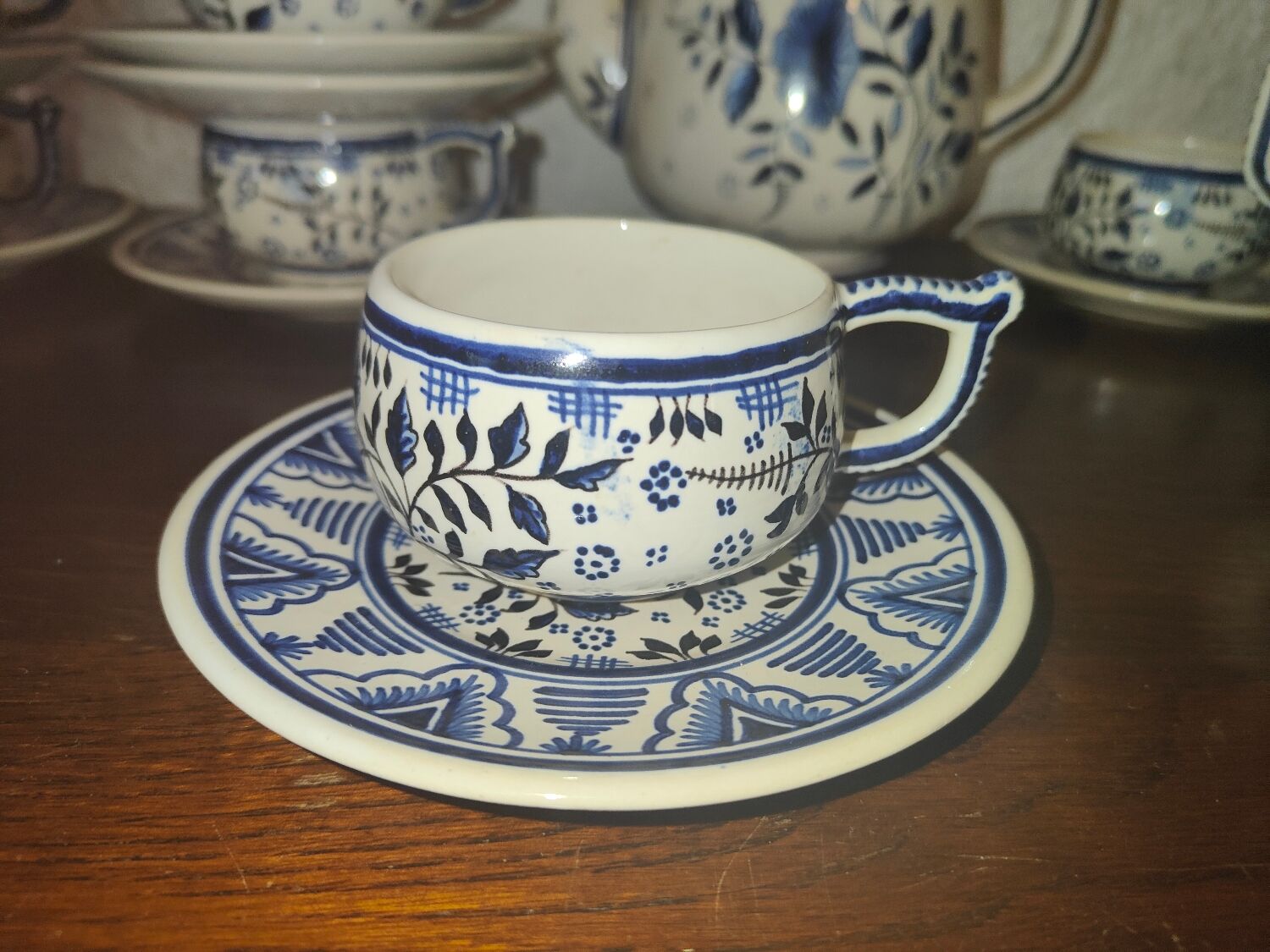 Henriot Quimper earthenware coffee set with floral decoration and elegant blue