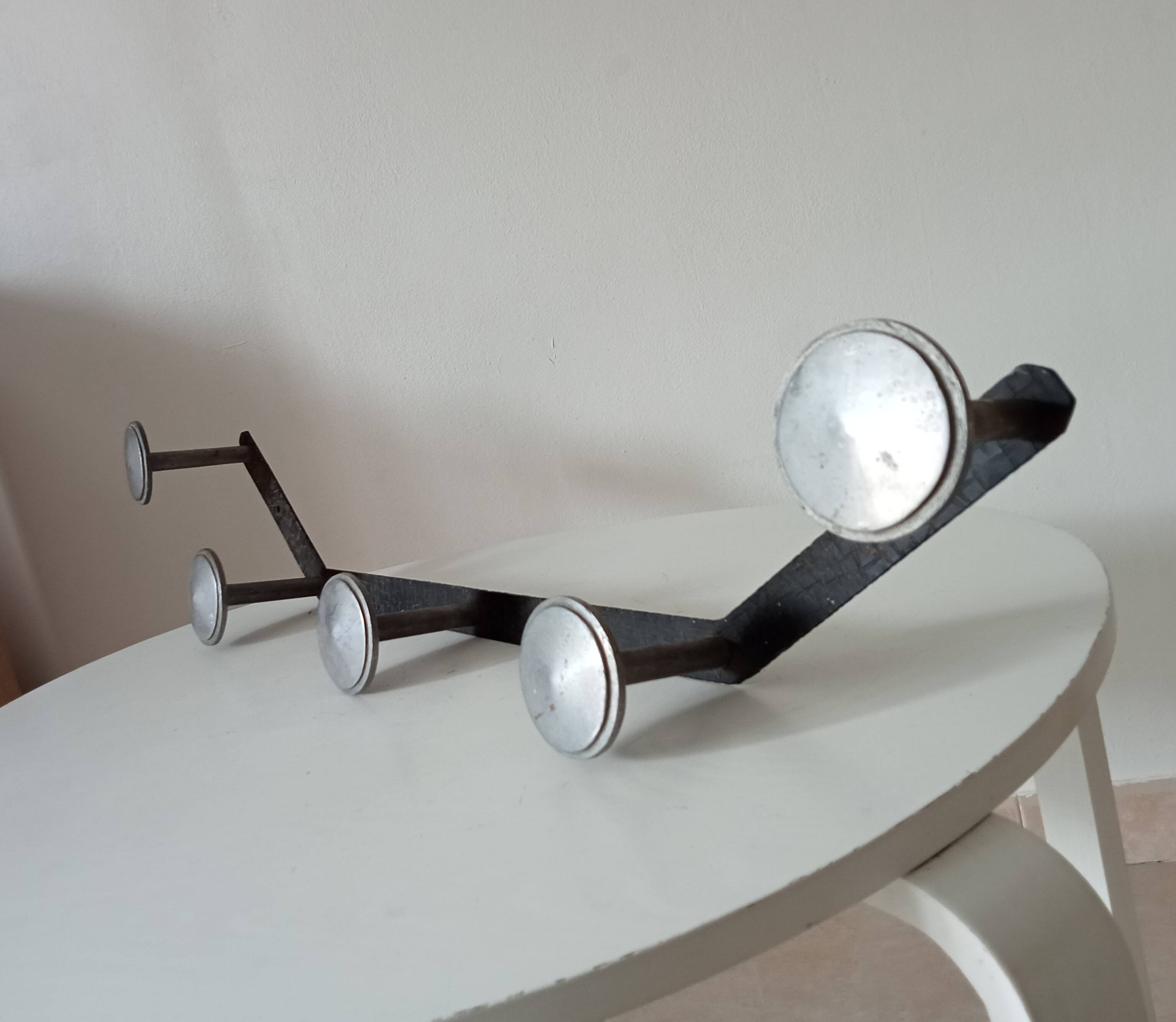 Vintage 1950s wall coat rack, wrought iron with chiselled details and solid aluminium.