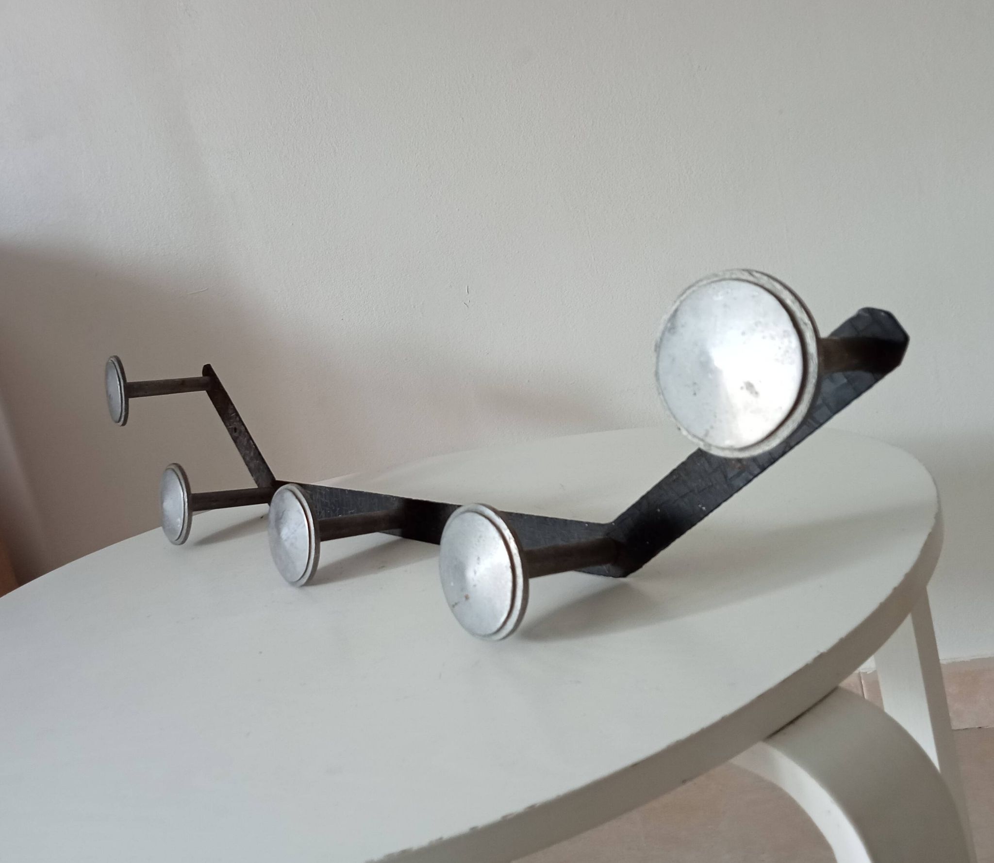 Vintage 1950s wall coat rack, wrought iron with chiselled details and solid aluminium.