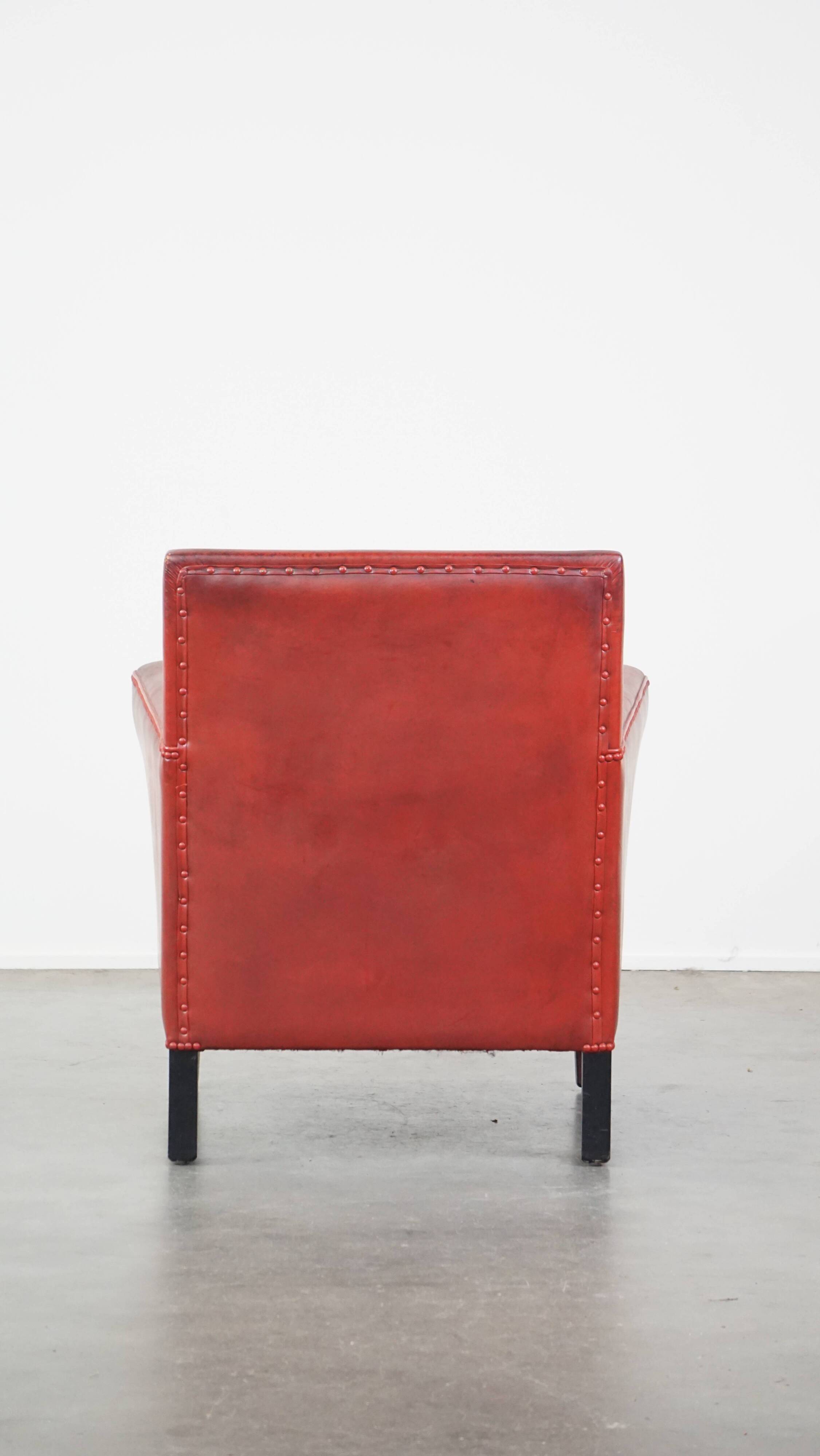 Red-painted armchair made of sheepskin leather