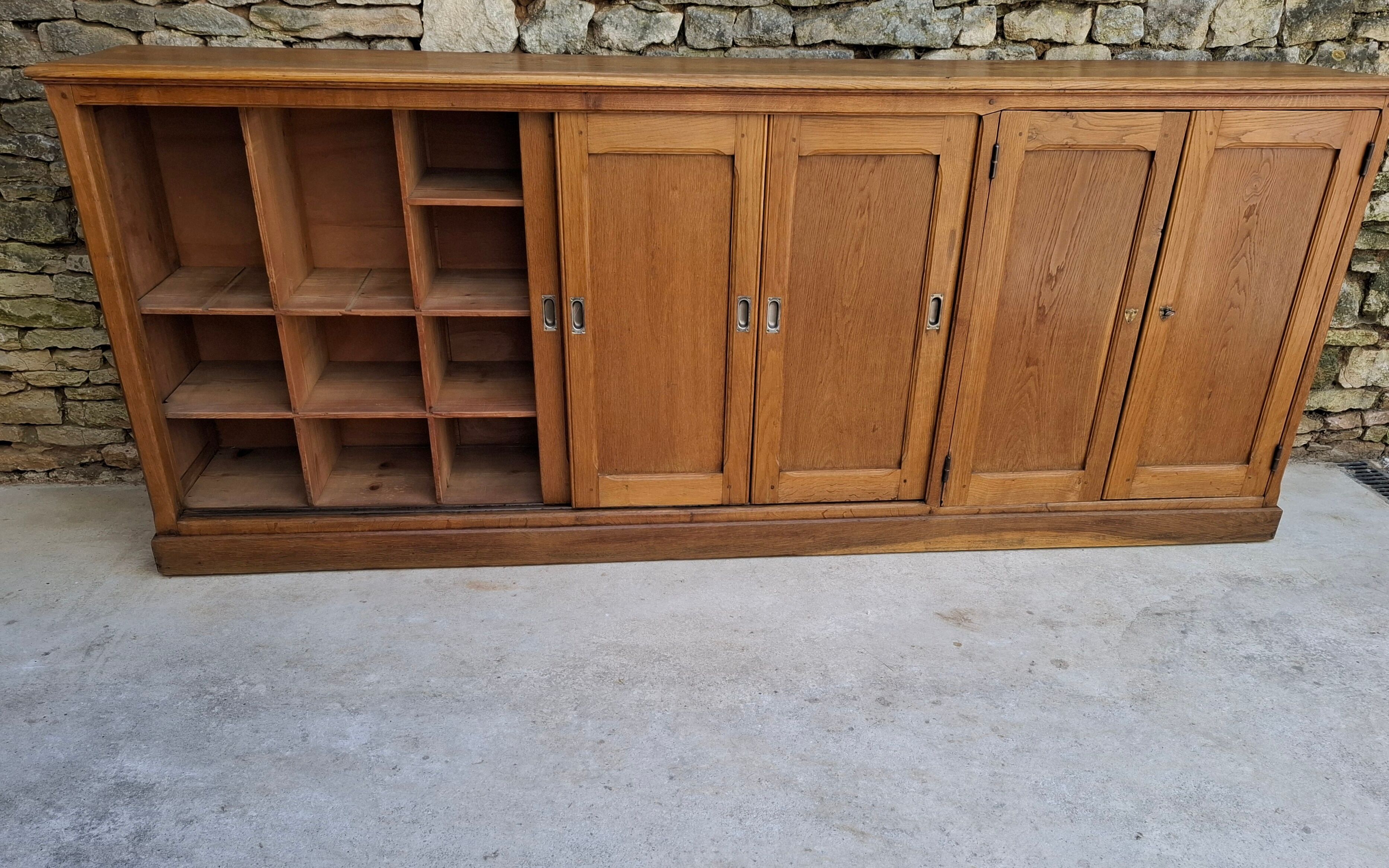 Oak workshop furniture with sliding doors.