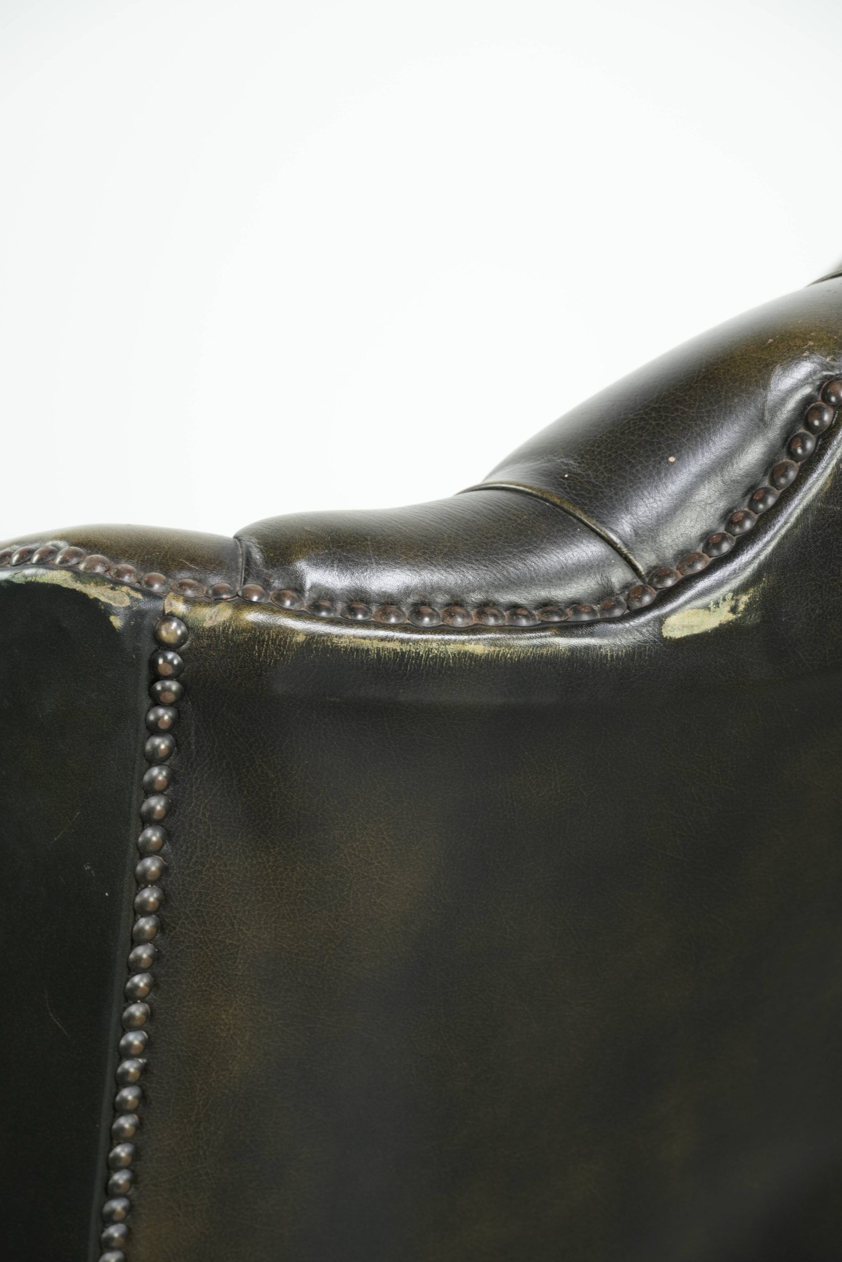 Vintage cowhide leather Chesterfield wingback armchair in a green colour