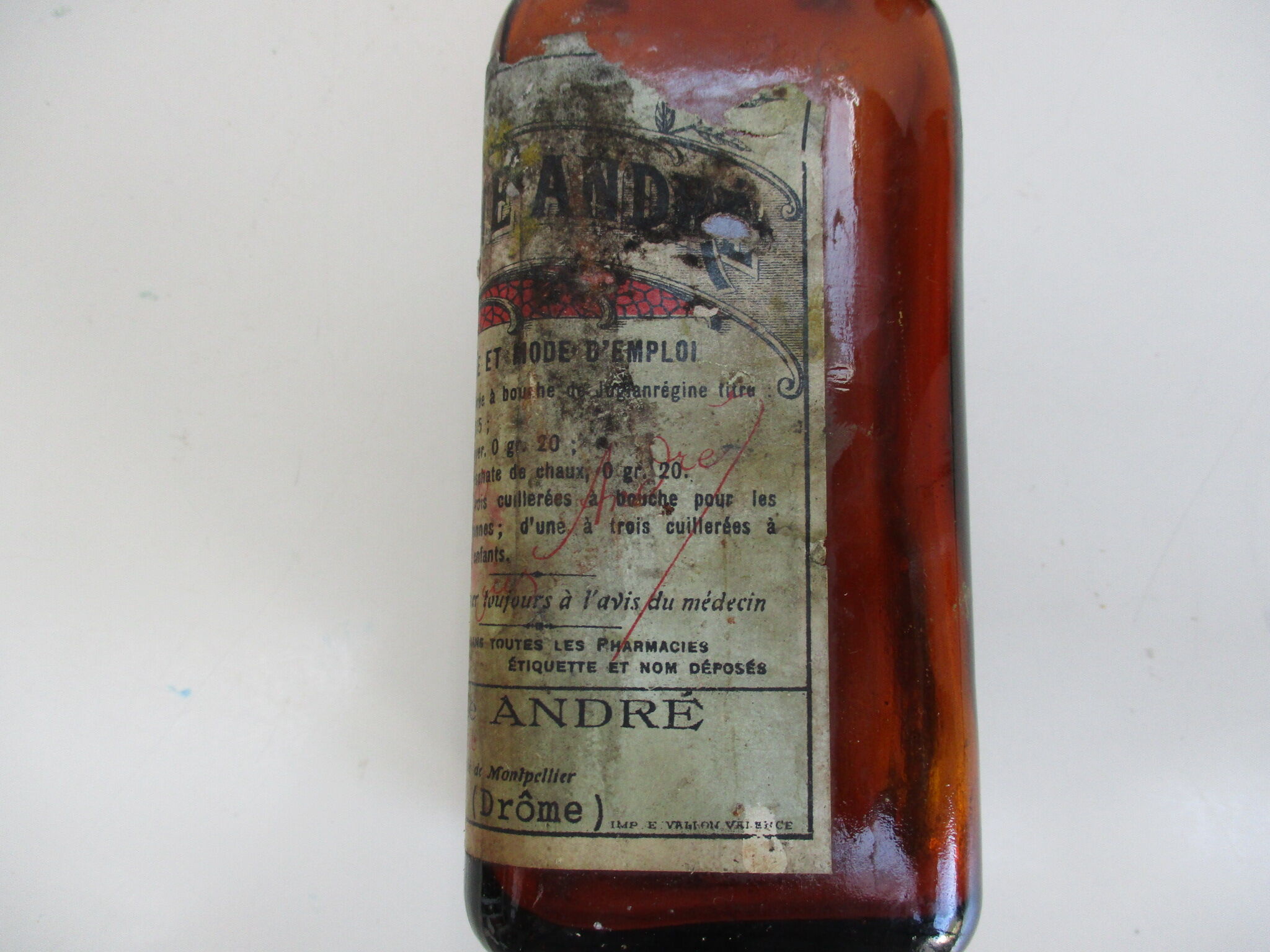 2 amber glass bottles with their old labels