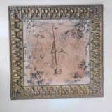 Antique tapestries framed in repoussé brass.