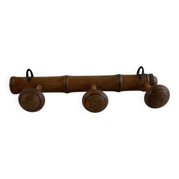 Wooden coat rack with three ball hooks.