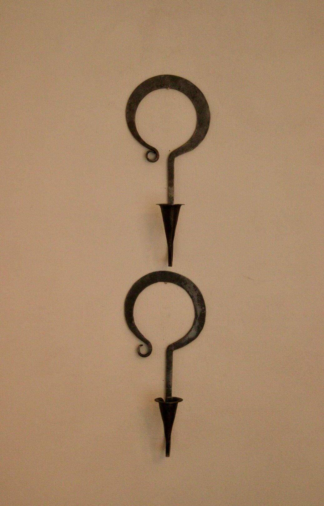 Pair of Swedish wall sconces in wrought iron, mid-20th century style, signed Akta.