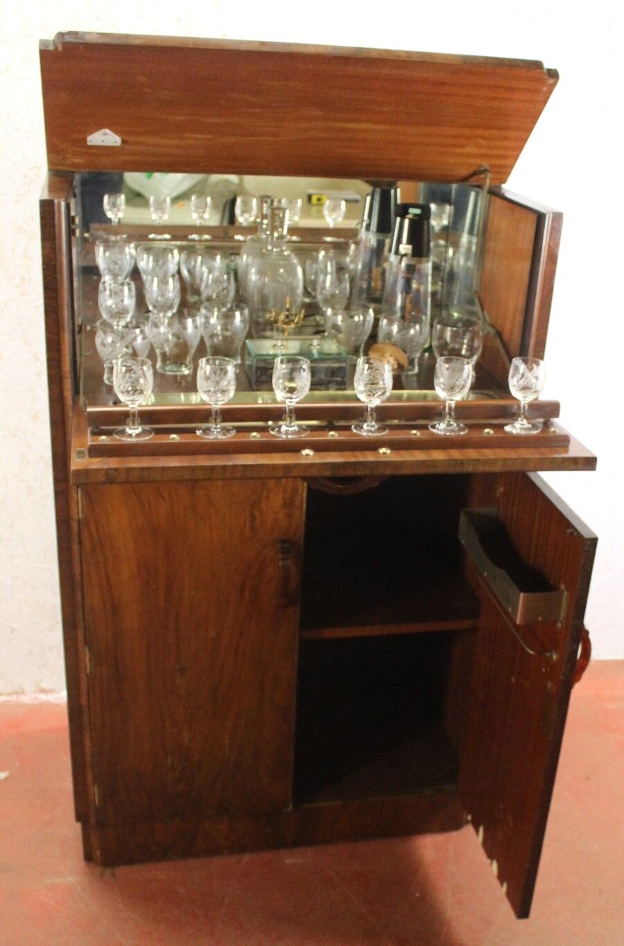 Walnut cocktail cabinet with glasses